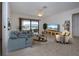 Living room with staged furniture and access to patio at 1613 Faxton Dr, Sun City Center, FL 33573