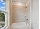 Clean bathroom featuring a shower/tub combo and large window at 1742 W Saint Louis St, Tampa, FL 33607