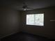 Simple bedroom with window and ceiling fan at 1820 Bough Ave # 3, Clearwater, FL 33760