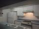 Galley kitchen with white cabinets, stainless steel appliances, and double sink at 1820 Bough Ave # 3, Clearwater, FL 33760