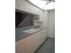Kitchen features ample counter space, white cabinets, and dishwasher at 1820 Bough Ave # 3, Clearwater, FL 33760