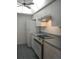 Kitchen boasts white cabinets, tile flooring, and a ceiling fan at 1820 Bough Ave # 3, Clearwater, FL 33760