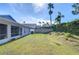 Large backyard with screened patio, grassy area, and privacy fence at 19304 Garden Quilt Cir, Lutz, FL 33558