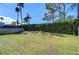 Spacious backyard with a fenced perimeter, lush lawn, and mature trees at 19304 Garden Quilt Cir, Lutz, FL 33558