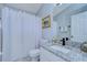 Small bathroom with granite countertop, white sink, and shower at 19304 Garden Quilt Cir, Lutz, FL 33558