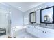 Bathroom boasts double vanity, granite countertop, and a large soaking tub at 19304 Garden Quilt Cir, Lutz, FL 33558