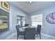 Bright breakfast nook with glass table and four gray chairs at 19304 Garden Quilt Cir, Lutz, FL 33558