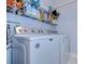 Laundry room with Maytag washer and dryer, and shelving at 19304 Garden Quilt Cir, Lutz, FL 33558