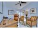Home office with wood desk, leather chair, and two armchairs at 19304 Garden Quilt Cir, Lutz, FL 33558