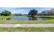 Community pond with lush green landscaping at 19304 Garden Quilt Cir, Lutz, FL 33558