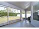 Screened porch with tiled floor and wicker chair at 19304 Garden Quilt Cir, Lutz, FL 33558