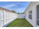 Small side yard with white vinyl fence and gate at 19304 Garden Quilt Cir, Lutz, FL 33558
