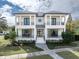 Two-story home with white exterior, landscaping, and stone walkway at 200 Cordova Ne Blvd, St Petersburg, FL 33704
