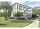 Two-story home with white exterior, landscaped yard, and walkway at 200 Cordova Ne Blvd, St Petersburg, FL 33704