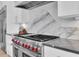 Modern kitchen with stainless steel range and marble backsplash at 200 Cordova Ne Blvd, St Petersburg, FL 33704