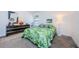Bedroom with a queen bed and tropical bedding at 204 Lennox W Rd, Palm Harbor, FL 34683
