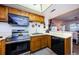 Kitchen boasts stainless steel appliances and wood cabinets at 204 Lennox W Rd, Palm Harbor, FL 34683