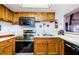 Updated kitchen with stainless steel appliances and wood cabinets at 204 Lennox W Rd, Palm Harbor, FL 34683