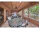 Screened-in patio area with table and chairs, near the pool at 204 Lennox W Rd, Palm Harbor, FL 34683