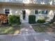 Well-maintained building entrance with landscaping and accessible ramp at 2285 Israeli Dr # 1, Clearwater, FL 33763