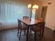 Bright dining area with a tile-top table and four chairs near a sliding glass door at 2285 Israeli Dr # 1, Clearwater, FL 33763