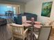 Bright dining room with glass table and four chairs, offering an open floor plan at 2285 Israeli Dr # 1, Clearwater, FL 33763