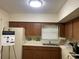 Galley kitchen with wood cabinets and a window above the sink at 2285 Israeli Dr # 1, Clearwater, FL 33763