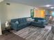 Spacious living room featuring a comfortable sectional sofa and large area rug at 2285 Israeli Dr # 1, Clearwater, FL 33763