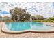 Refreshing kidney-shaped pool surrounded by a brick patio at 2285 Israeli Dr # 1, Clearwater, FL 33763