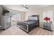 Main bedroom with large bed, gray dresser, and wood-look floors at 2397 Ainsworth Ave, Spring Hill, FL 34609