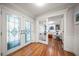 Bright and spacious entryway with hardwood floors and stained glass doors at 301 Osceola Rd, Belleair, FL 33756