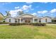 House front with gray brick exterior and manicured landscaping at 301 Osceola Rd, Belleair, FL 33756