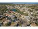 An aerial view of a residential neighborhood with houses and a pond at 3457 Foxhall Dr, Holiday, FL 34691