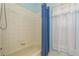 Clean bathroom with a tub and shower, and a window at 3457 Foxhall Dr, Holiday, FL 34691