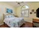 Guest bedroom with vaulted ceiling and wood floors at 3457 Foxhall Dr, Holiday, FL 34691
