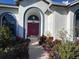 Front entry with double doors and landscaping at 3457 Foxhall Dr, Holiday, FL 34691