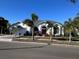 Single-Gathering home with a red door and palm trees at 3457 Foxhall Dr, Holiday, FL 34691