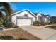 House with a two-car garage and well-maintained landscaping at 3457 Foxhall Dr, Holiday, FL 34691