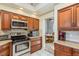 Spacious kitchen with stainless steel appliances and granite countertops at 3457 Foxhall Dr, Holiday, FL 34691
