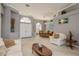 Spacious living room with beige leather furniture and a view of the pool at 3457 Foxhall Dr, Holiday, FL 34691