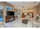 Open living space with kitchen, leather furniture, TV at 3457 Foxhall Dr, Holiday, FL 34691