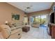 Relaxing living room with leather furniture and pool view at 3457 Foxhall Dr, Holiday, FL 34691