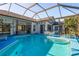 Inviting screened-in pool area with plenty of seating at 3457 Foxhall Dr, Holiday, FL 34691