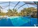 Screened pool and patio with plenty of room for lounging at 3457 Foxhall Dr, Holiday, FL 34691