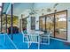 Relaxing poolside patio with table, chairs, and a grill at 3457 Foxhall Dr, Holiday, FL 34691