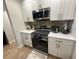Updated kitchen features white cabinets, quartz countertops, and stainless steel appliances at 4420 Pompano Se Dr, St Petersburg, FL 33705