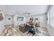 Bonus room with leather furniture, large TV, and wood-look floors at 5230 Admiral Pointe Dr, Apollo Beach, FL 33572