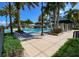 Community lap pool with lounge chairs and patio umbrellas at 5230 Admiral Pointe Dr, Apollo Beach, FL 33572