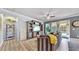 Spacious living room with striped sofa, large TV, and hardwood floors at 5230 Admiral Pointe Dr, Apollo Beach, FL 33572