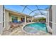 Relaxing pool and spa with patio furniture under a screened enclosure at 5230 Admiral Pointe Dr, Apollo Beach, FL 33572